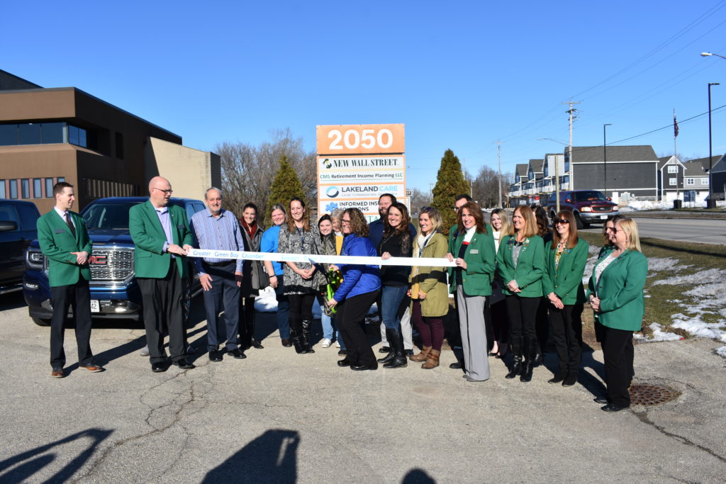 Lakeland Care staff and Greater Green Bay Chamber Ambassadors gather for a ribbon cutting.